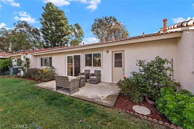 back of house with an outdoor hangout area, a patio area, central air condition unit, and a yard