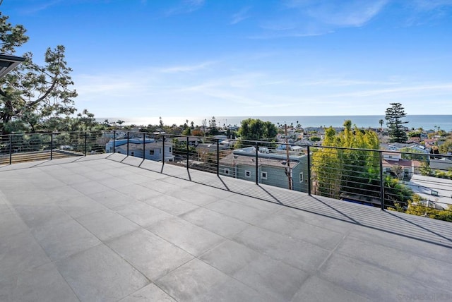 view of patio / terrace with a balcony and a water view