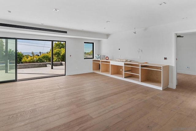 unfurnished room with light wood-type flooring