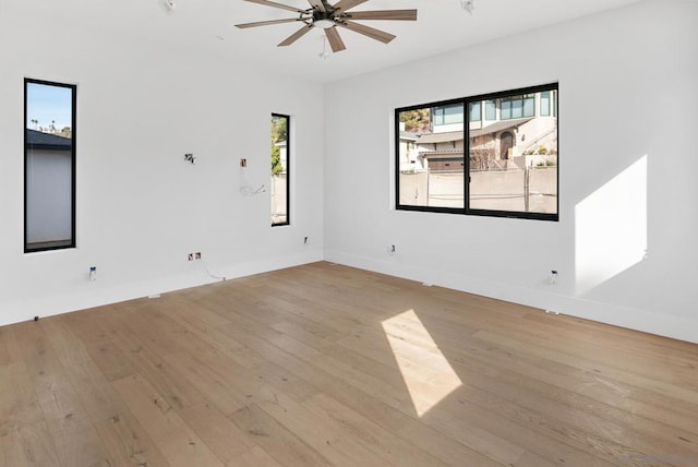 unfurnished room with ceiling fan and light wood-type flooring