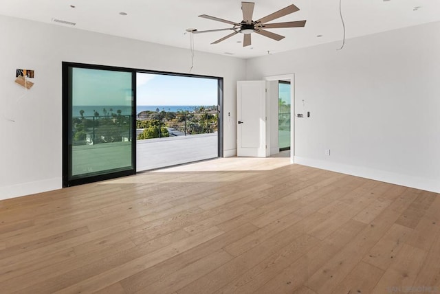 unfurnished room featuring ceiling fan and light hardwood / wood-style floors