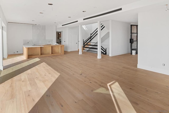 unfurnished living room featuring light hardwood / wood-style floors