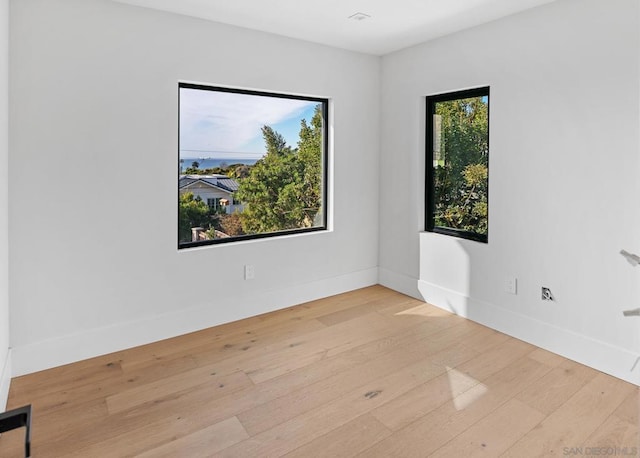 empty room with light hardwood / wood-style flooring