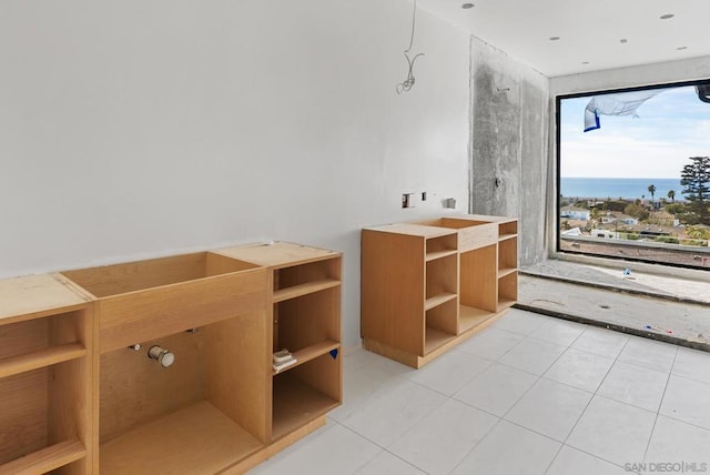 bathroom featuring tile patterned flooring and a water view