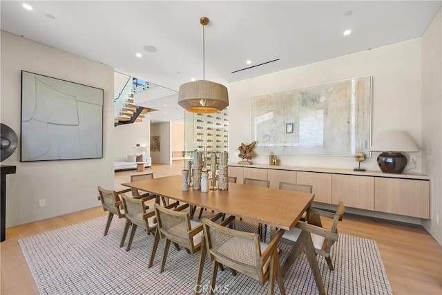 dining space with light hardwood / wood-style flooring