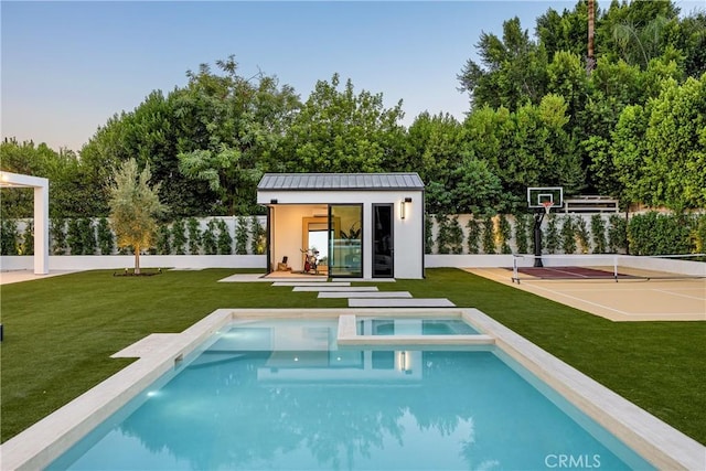 view of pool with an outbuilding, tennis court, a lawn, and basketball court