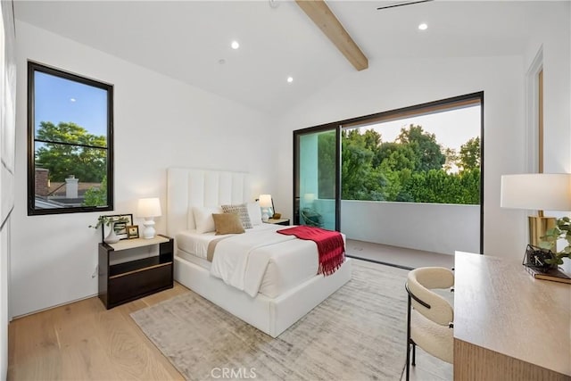 bedroom featuring light wood-type flooring and vaulted ceiling with beams