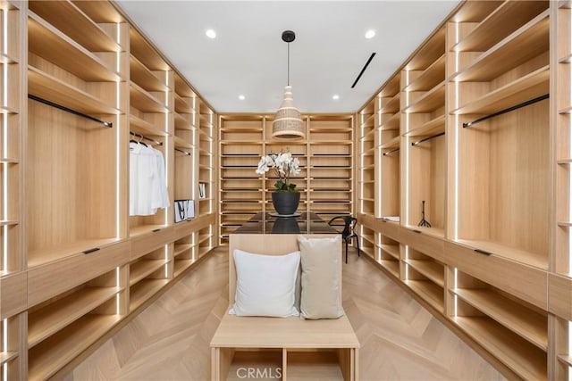 spacious closet with light parquet flooring