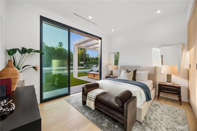 bedroom with light hardwood / wood-style flooring and access to outside