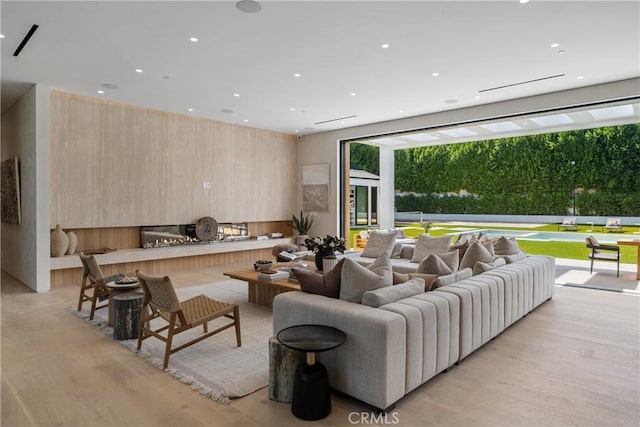 living room with light wood-type flooring and a fireplace