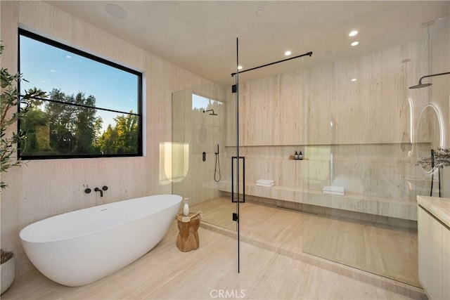 bathroom featuring separate shower and tub