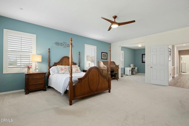 carpeted bedroom featuring multiple windows and ceiling fan