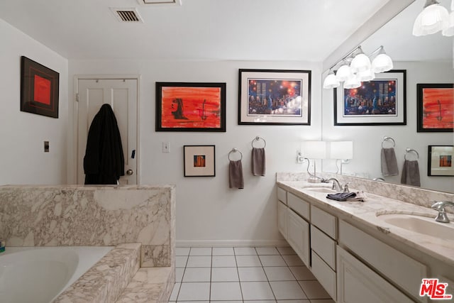 bathroom with vanity, tile patterned flooring, and a bathing tub