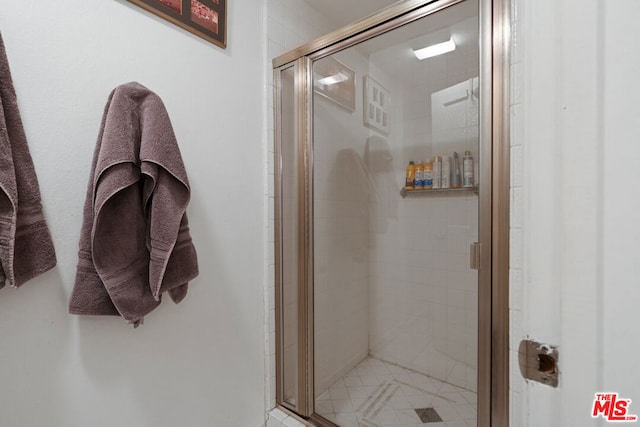 bathroom with a shower with shower door