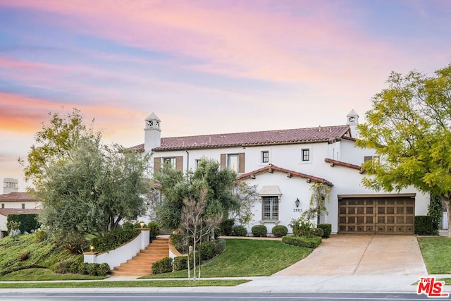 mediterranean / spanish-style home with a yard