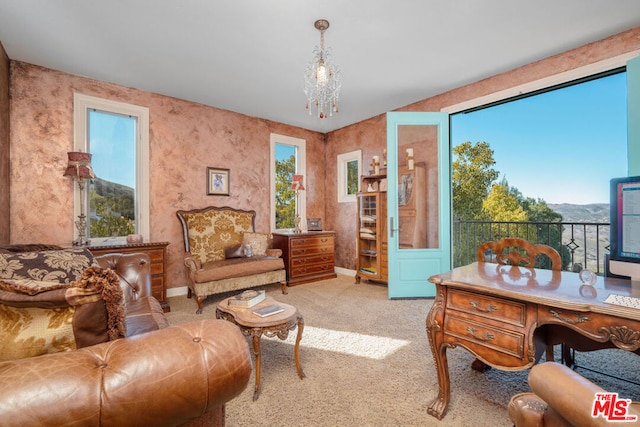 sitting room with light colored carpet and a notable chandelier