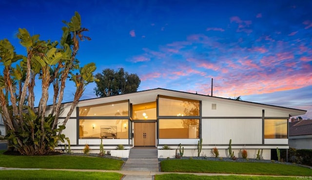 contemporary house with a lawn