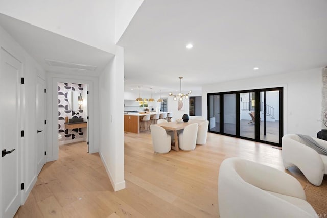 interior space with a chandelier and light hardwood / wood-style flooring