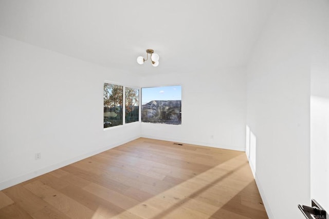 spare room with hardwood / wood-style floors