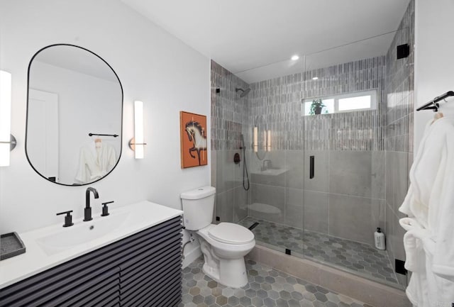 bathroom with vanity, tile patterned flooring, toilet, and walk in shower