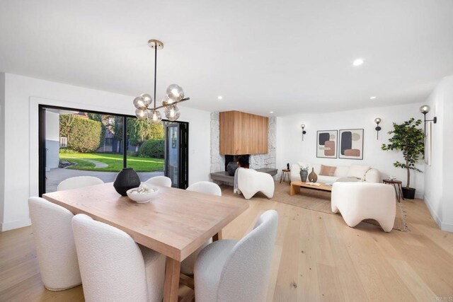 dining room featuring a notable chandelier and light wood-type flooring