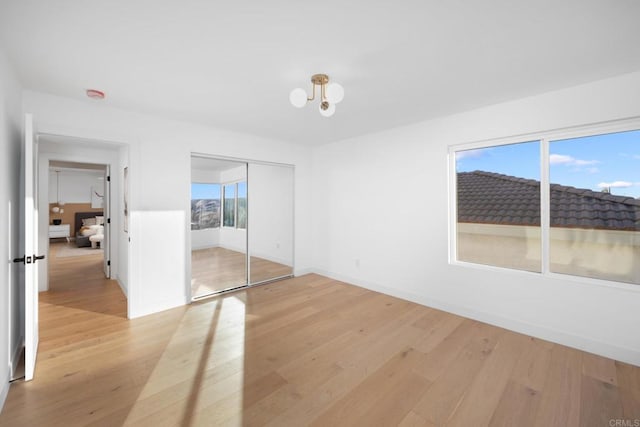 unfurnished bedroom with a closet and light hardwood / wood-style flooring