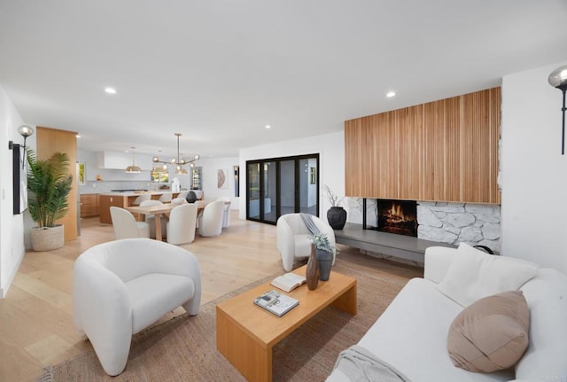 living room featuring light hardwood / wood-style floors and a chandelier