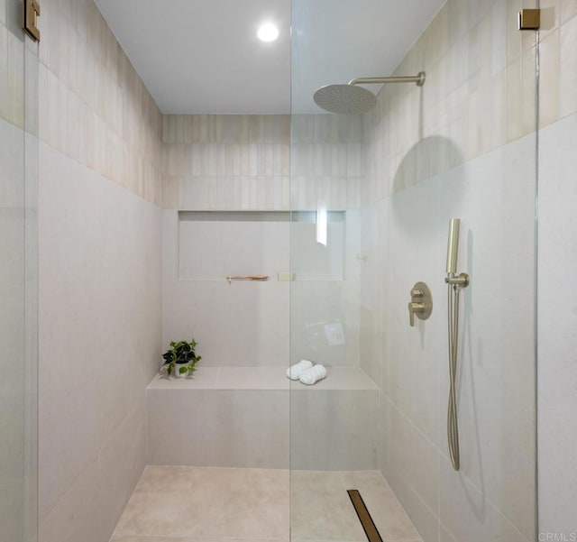 bathroom with a tile shower