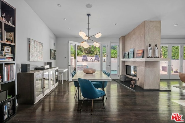 dining area featuring dark wood-type flooring, french doors, a notable chandelier, and a wealth of natural light