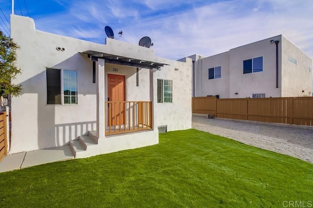 rear view of house featuring a lawn