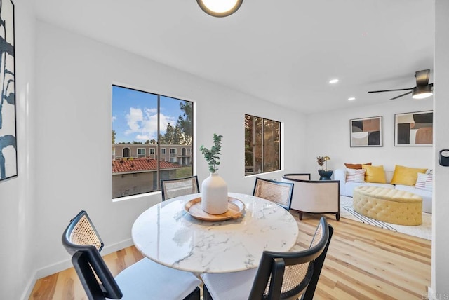 dining room with light wood-type flooring and ceiling fan