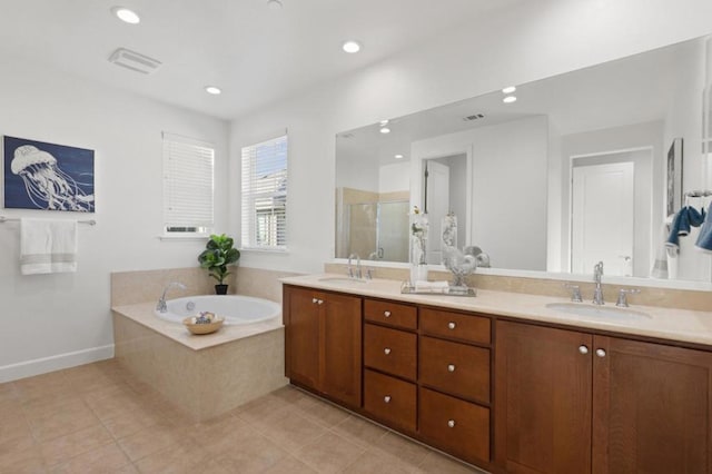 bathroom with independent shower and bath, tile patterned floors, and vanity