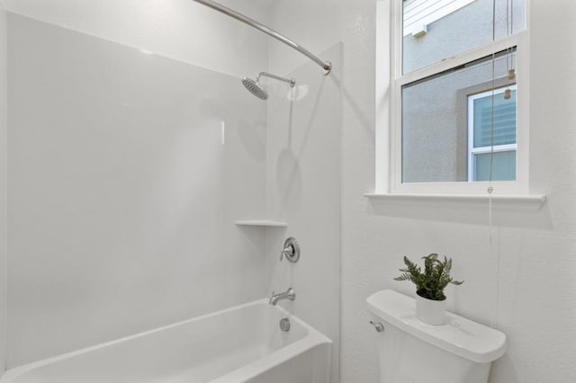 bathroom with shower / bathtub combination and toilet