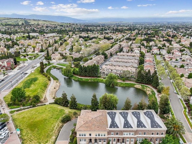 drone / aerial view featuring a water and mountain view