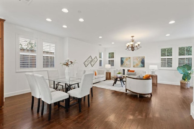 dining space with a chandelier, a wealth of natural light, and dark hardwood / wood-style floors