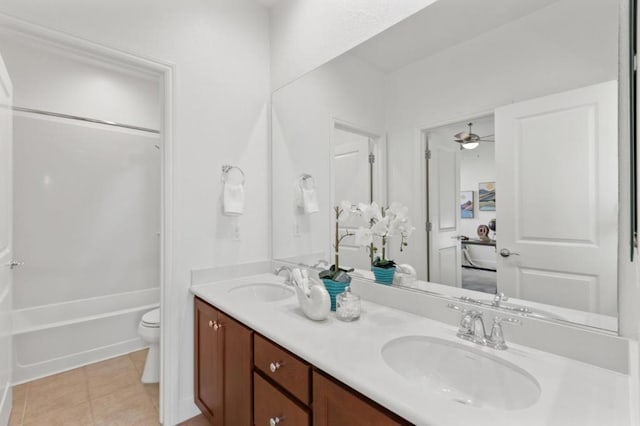 full bathroom with toilet, tile patterned floors, vanity, ceiling fan, and shower / washtub combination