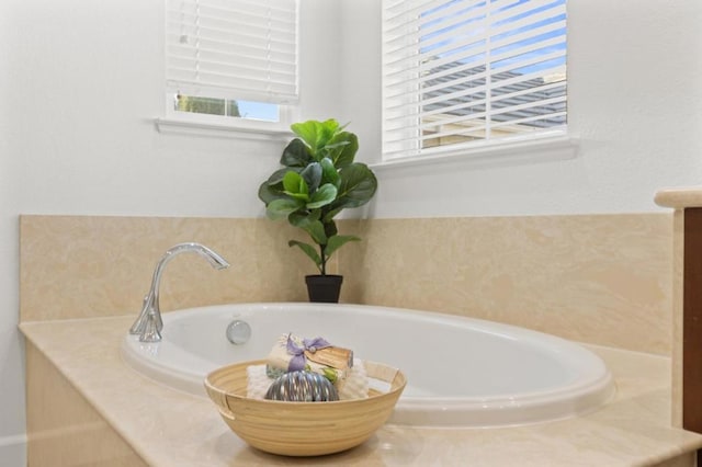 bathroom featuring a washtub and vanity