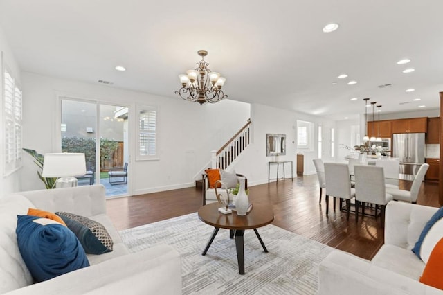 living room featuring an inviting chandelier and hardwood / wood-style floors