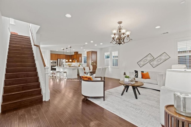 living room featuring dark hardwood / wood-style floors and a notable chandelier