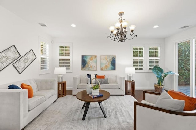 living room with a chandelier and light hardwood / wood-style floors