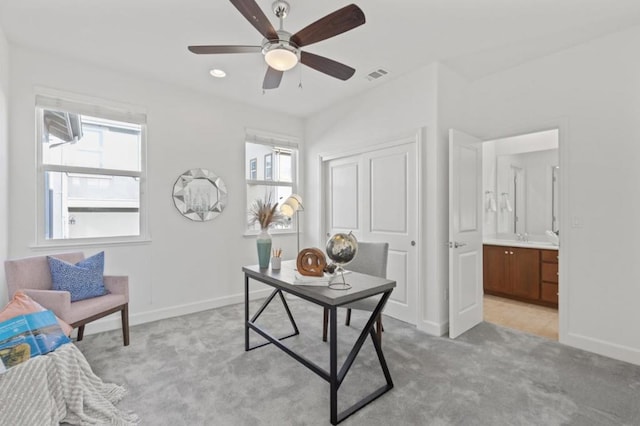 carpeted office featuring ceiling fan