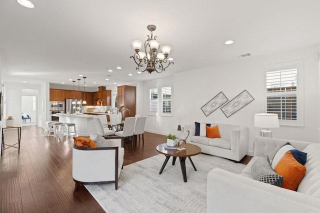 living room featuring hardwood / wood-style floors and an inviting chandelier