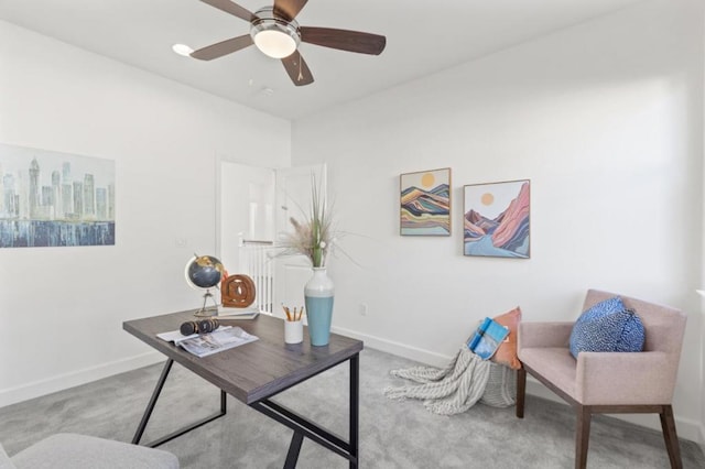 home office featuring ceiling fan and light carpet