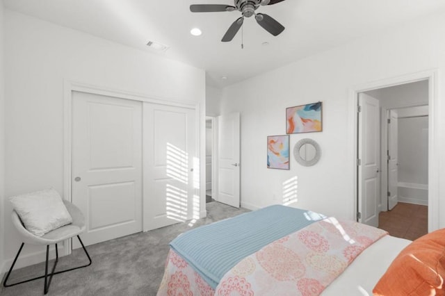 carpeted bedroom featuring a closet and ceiling fan