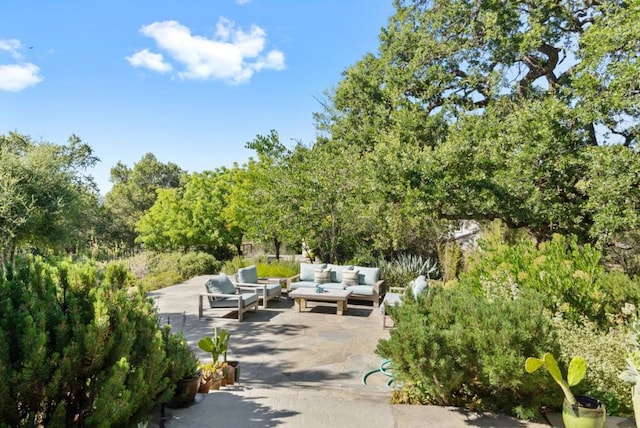 surrounding community featuring an outdoor living space and a patio