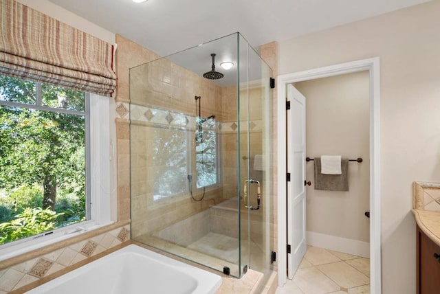 bathroom with plenty of natural light, tile patterned flooring, vanity, and shower with separate bathtub