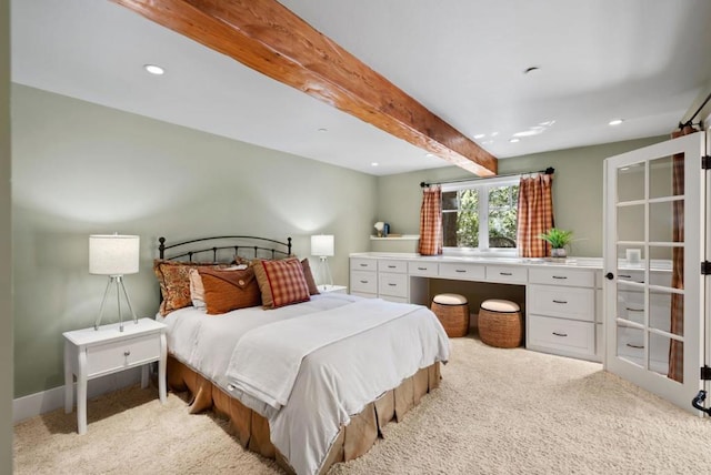 carpeted bedroom with beam ceiling