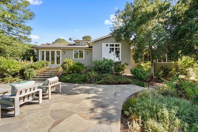 rear view of property featuring french doors and a patio