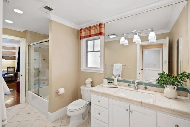 full bathroom featuring toilet, vanity, tile patterned floors, and ornamental molding