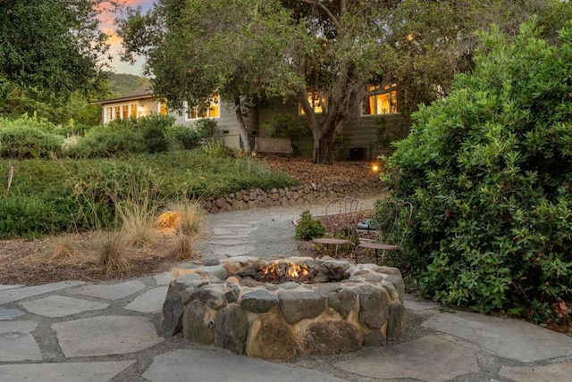 yard at dusk with a fire pit